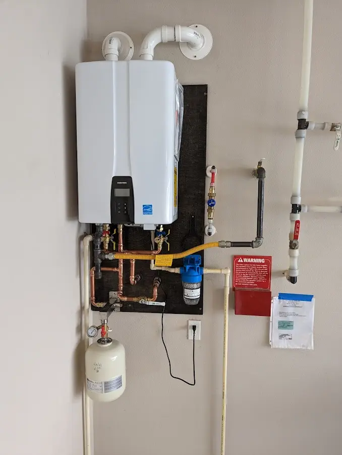 Professional plumber installing copper piping in a Powell home